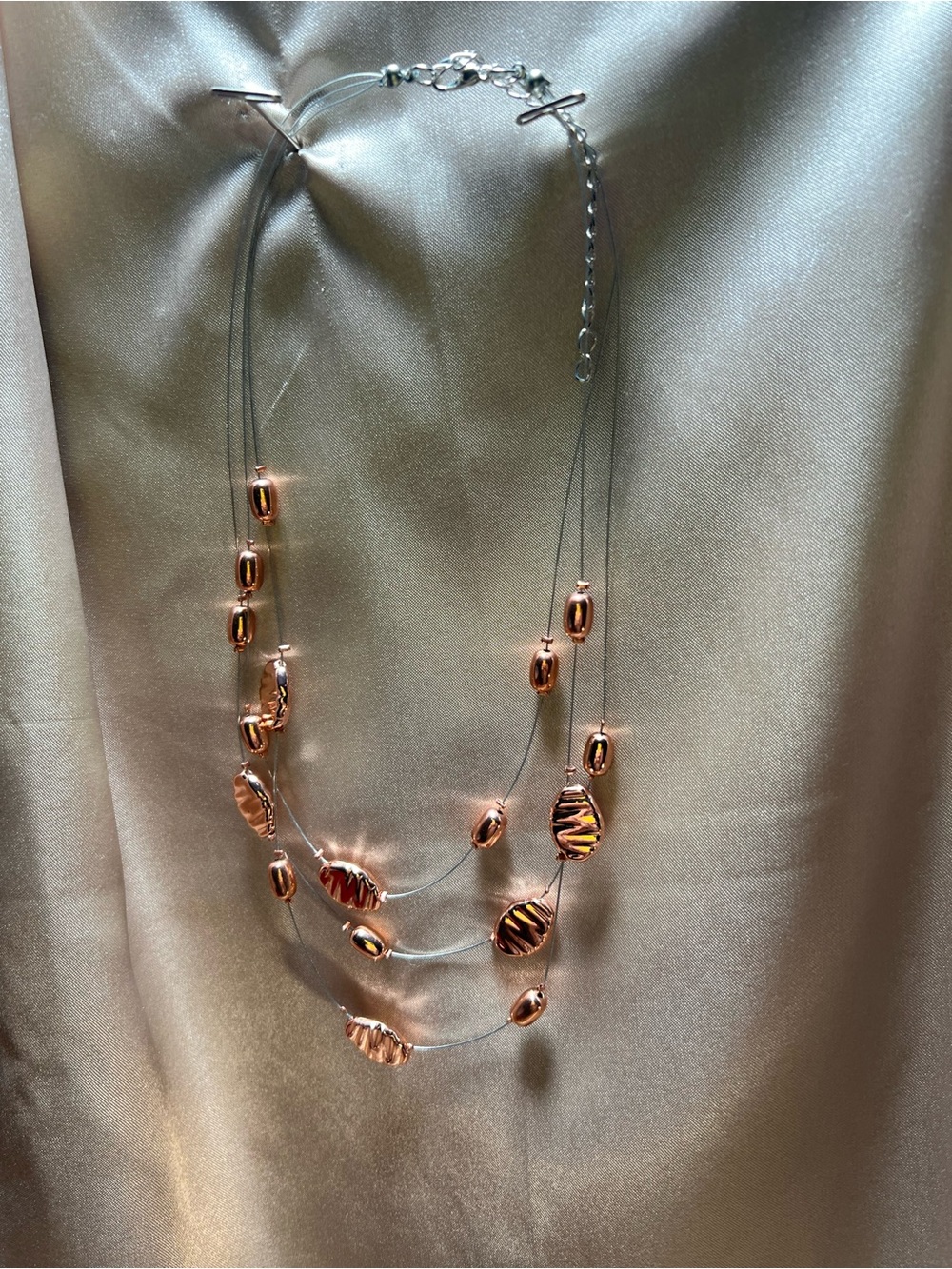 Elegant Rose Gold Multi-Strand Beaded Necklace with matching earrings.